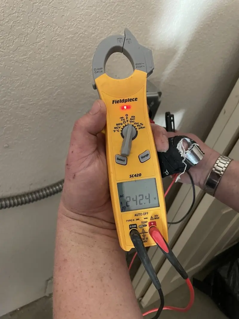 Voltage testing with clamp meter during Electrical Installation Services in Clever